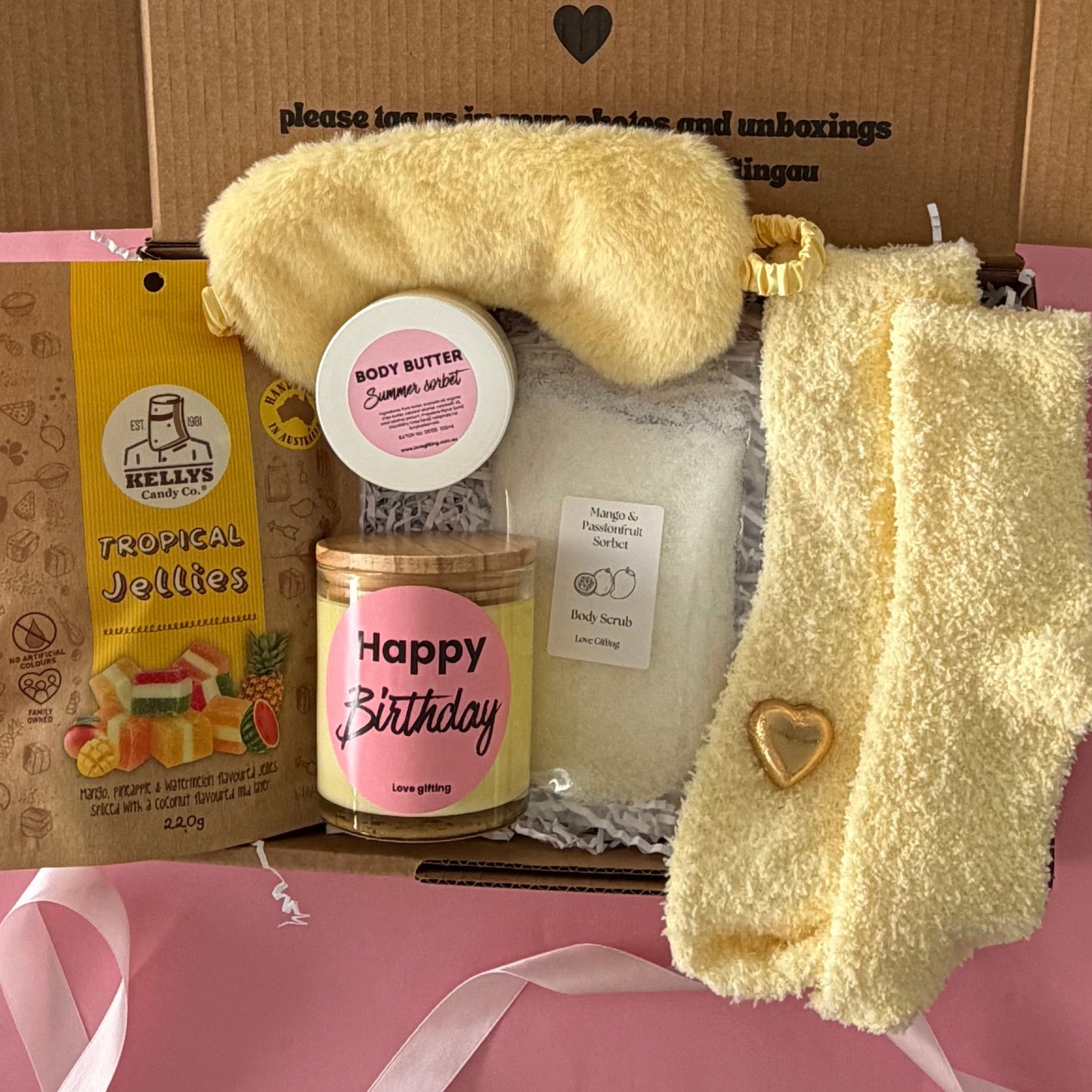 Tropical gift box includes cocktail, sleep mask, tropical lollies, mango scrub and socks , candle, body butter