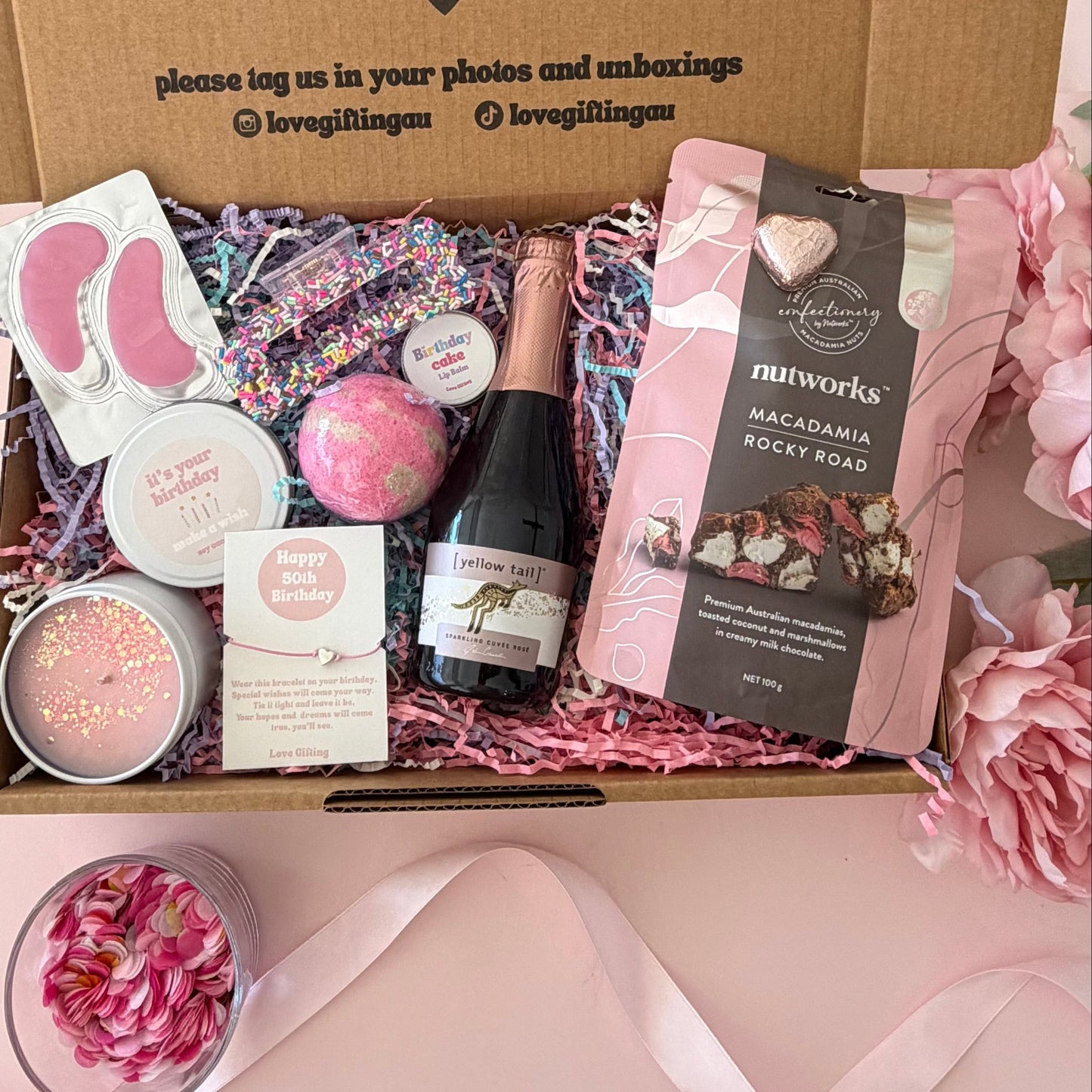 50th birthday gift box including prosecco, bath bomb, candle, braceklet, rocky road, hair clip and lipbalm