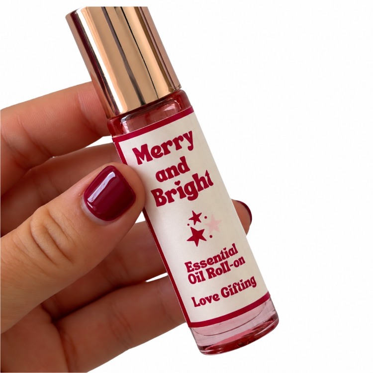 Merry and Bright Essential Oil Roll-On held in hand with burgundy nails – Christmas gift box add-on Australia