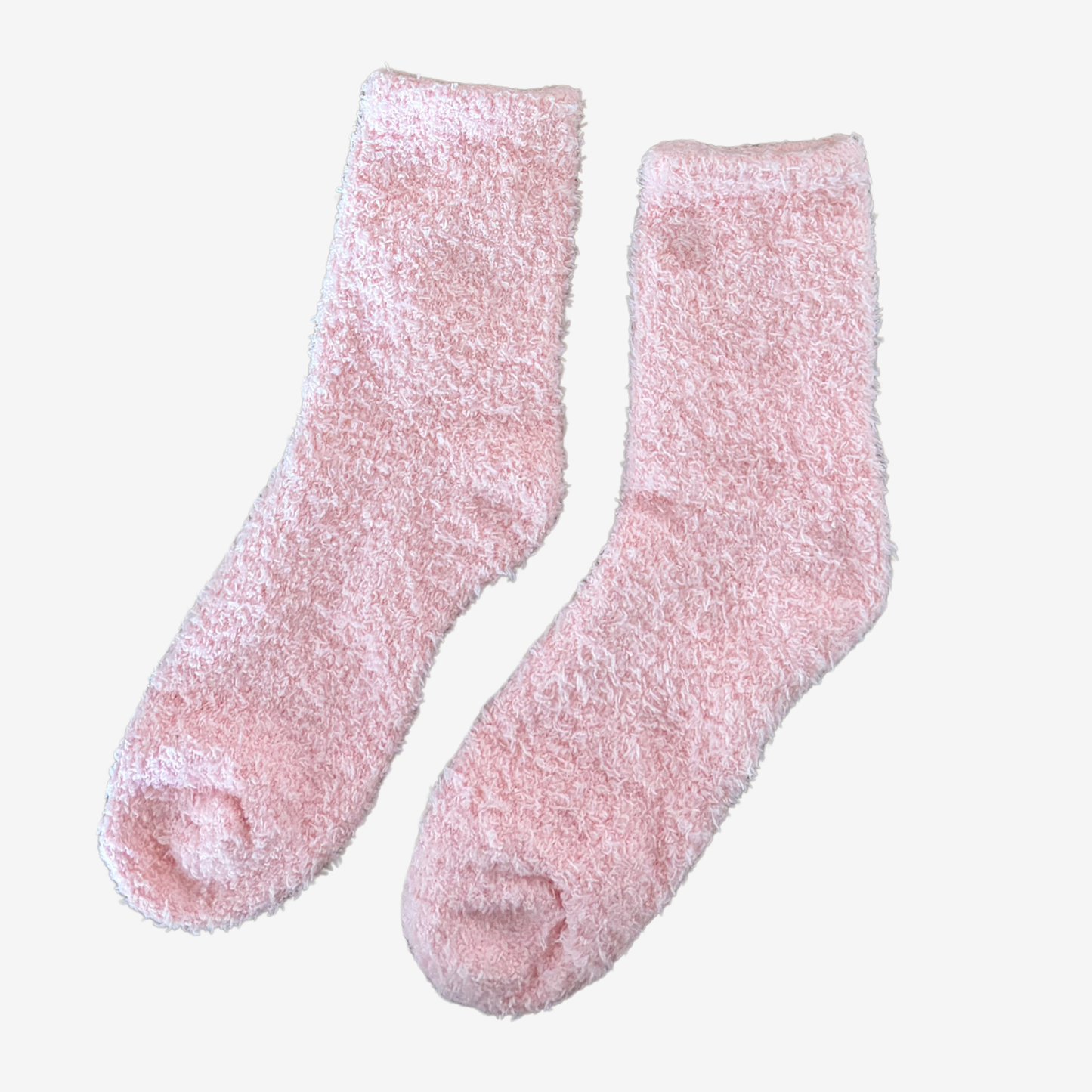 Pair of pink fuzzy socks on a white background
