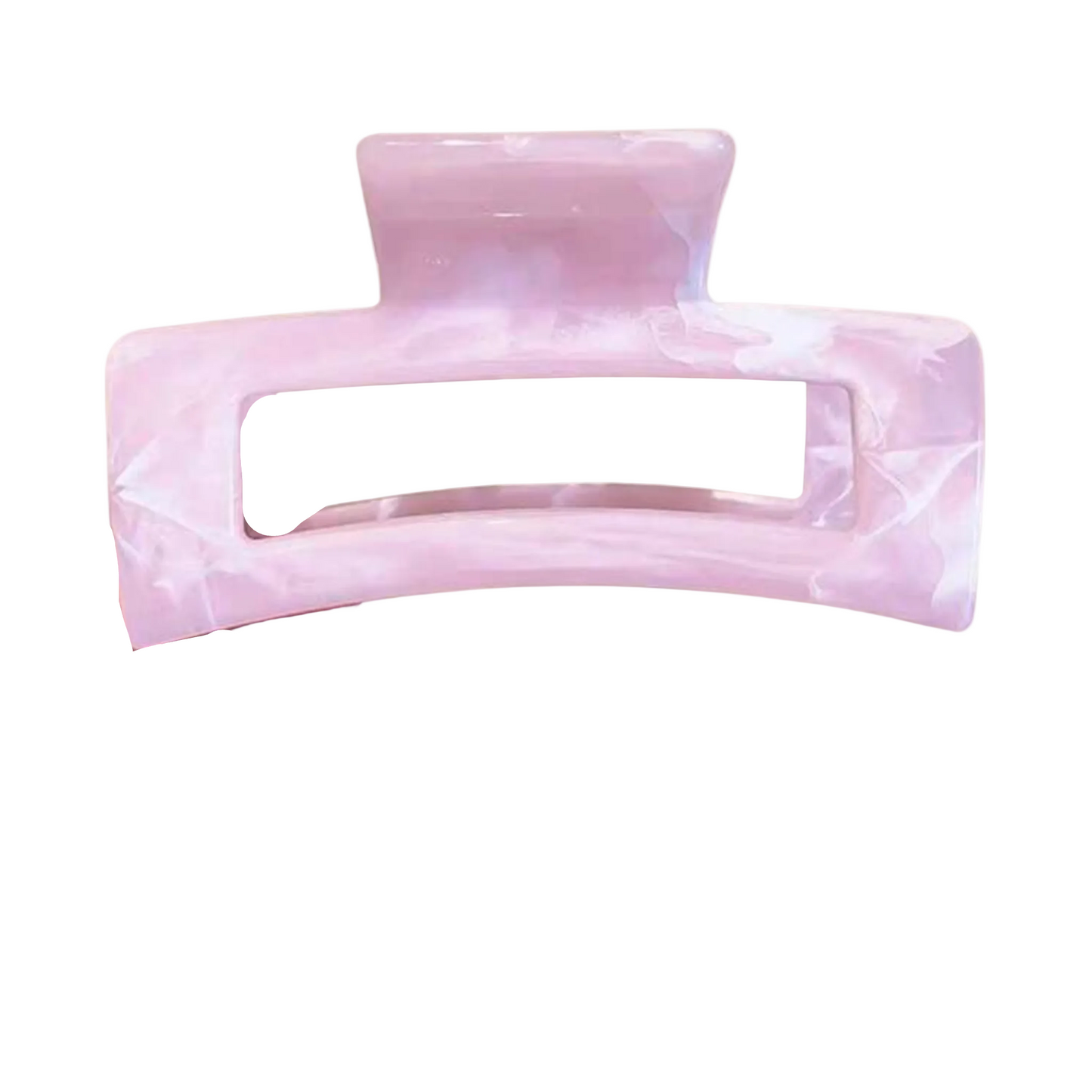 Pink marbled hair clip held by a hand on a white background