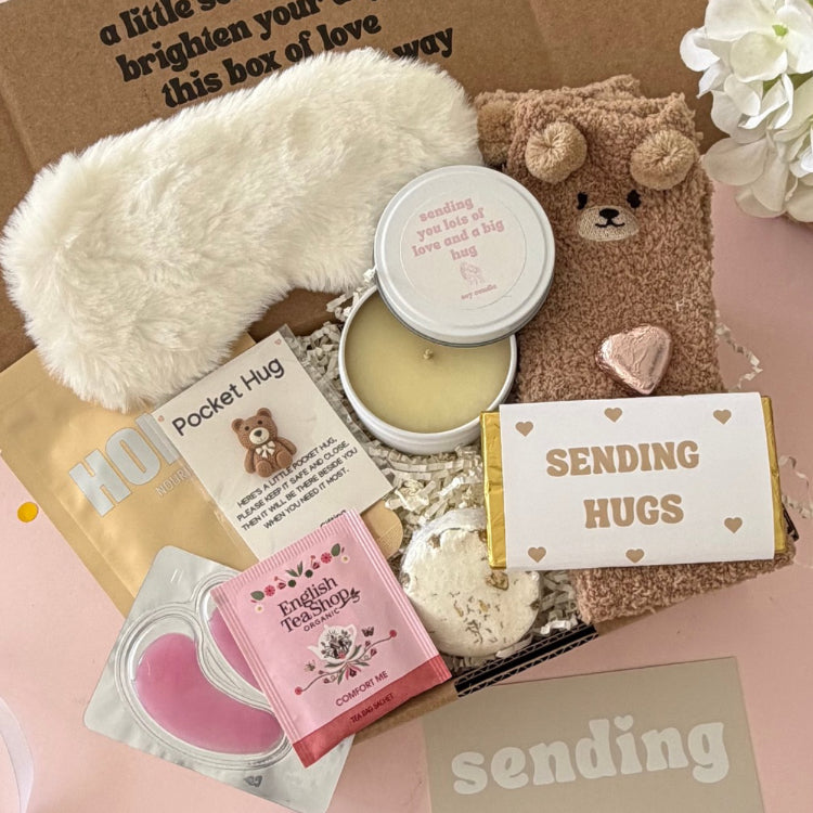 Sending Hugs Gift Box including candle, bear socks, lapcos facemask sheet, teabag, under eye, choc heart. shower steamer, bear pocket hug and Sending Hugs Chocolate