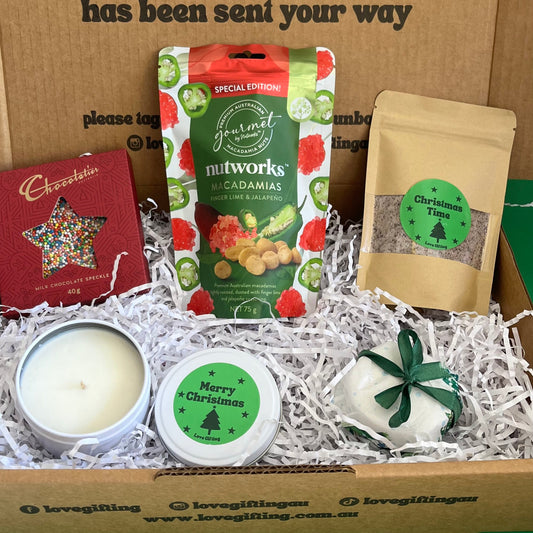 Gift box with candles, snacks, chocolate star