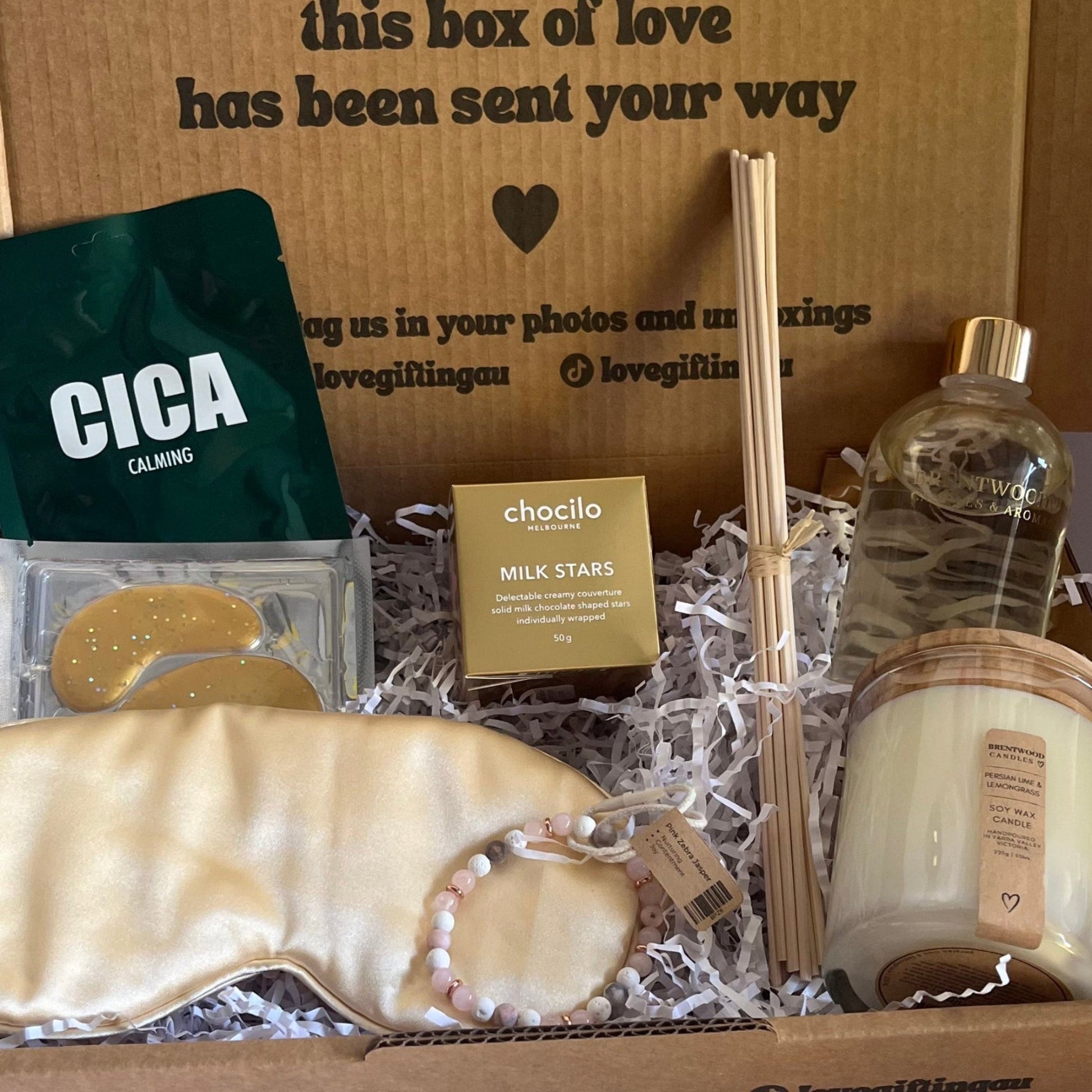 Gift box with various items including soap, a bottle, and a Cica product on a white background.