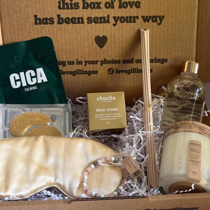Gift box with various items including soap, a bottle, and a Cica product on a white background.