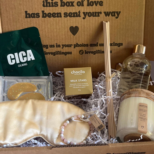 Gift box with various items including soap, a bottle, and a Cica product on a white background.