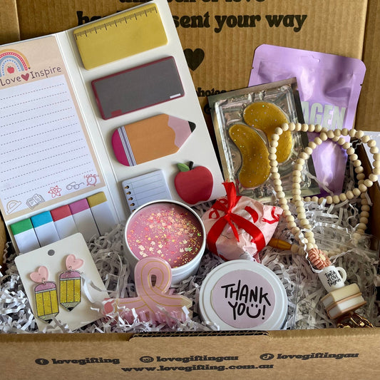 Box of love with  teacher stationery items and decorative elements, featuring a message on the box.