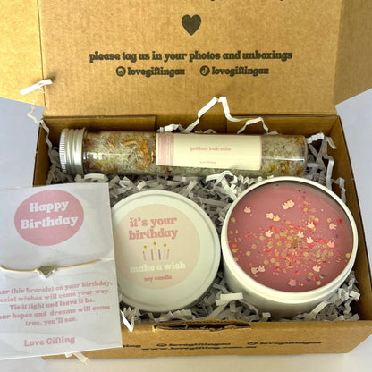Gift box with candles and a card on a white background