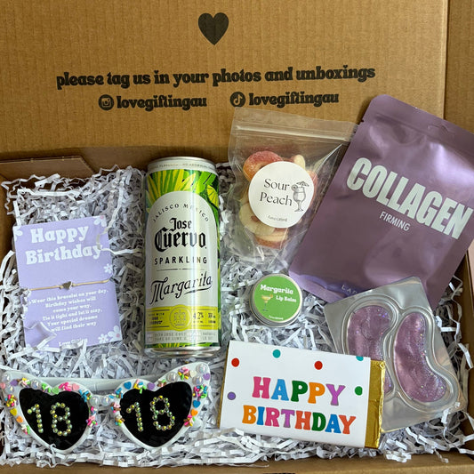 Gift box with birthday-themed items including a can of beer, cookies, and a card, with a message on the box.