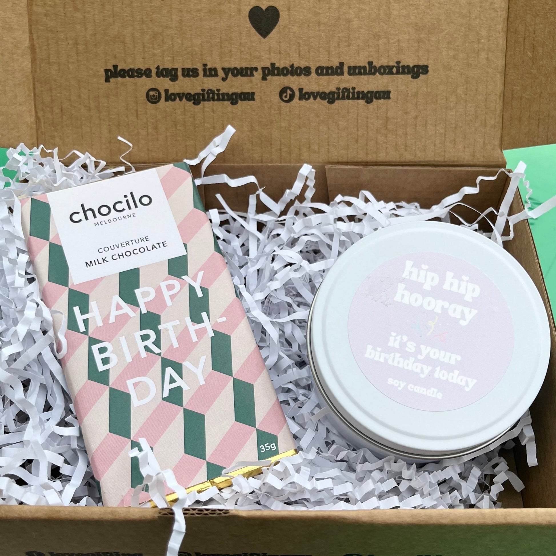 Gift box with a chocolate bar and candle.