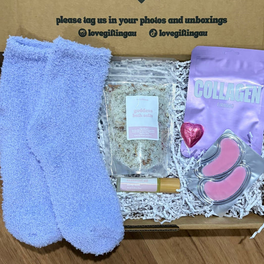 Pamper Gift Box including socks, a heart-chocolate, energy roller, bath salts.