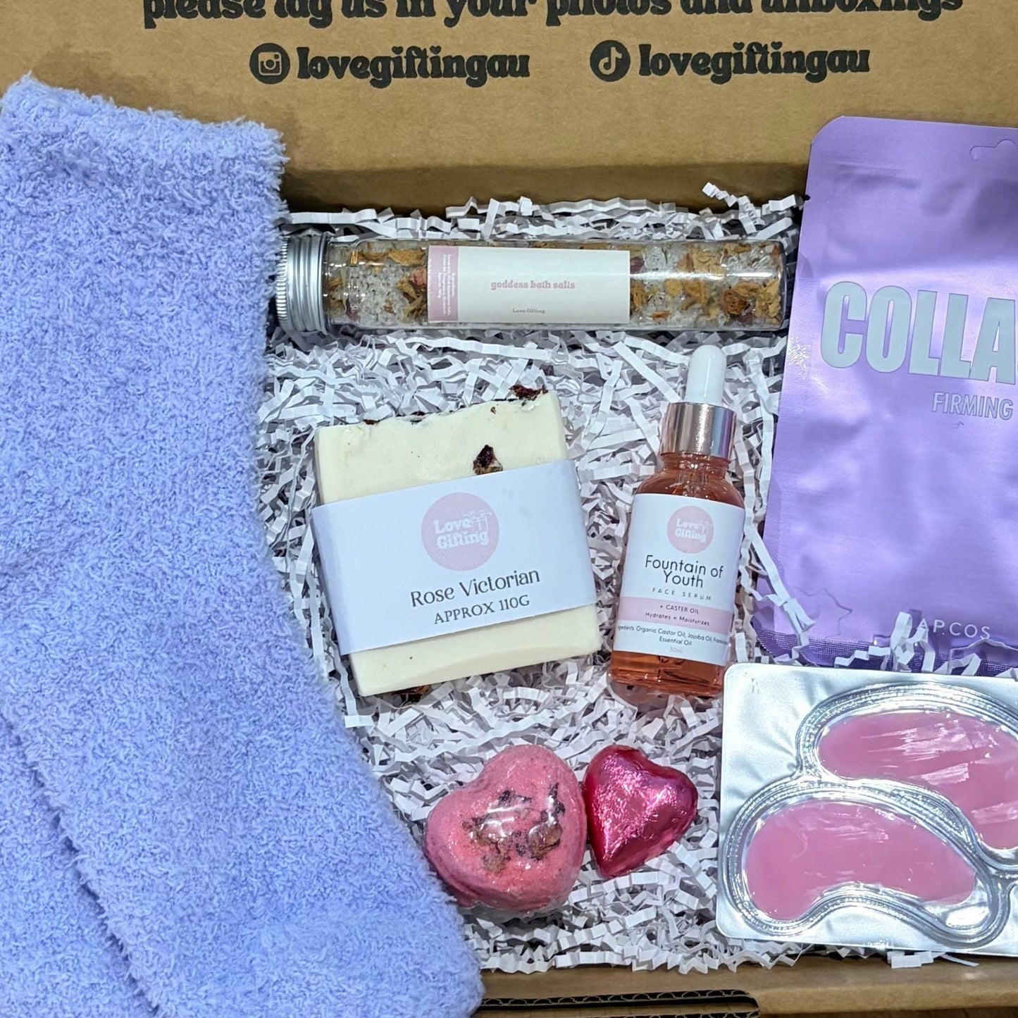 Box of self-care items with a message on a wooden surface