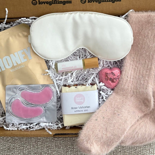 Gift set with sleep mask, soap, and other items in a box labeled 'lovegiftingau'.