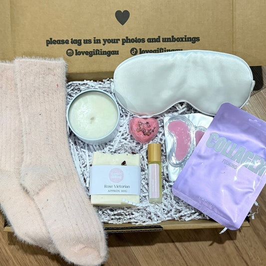 Pamper Gift Box, sleep mask, facemask sheet, socks, energy roll on, candle.