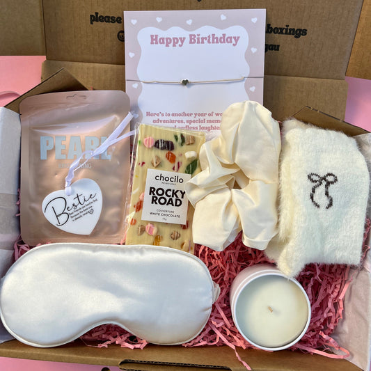 Bestie ,  friend gift box with self-care items including a candle, stain cream eye mask, and white Rocky Road bar, mini Bestie ornament, Happy birthday bracelet, Jumbo Scrunchie.