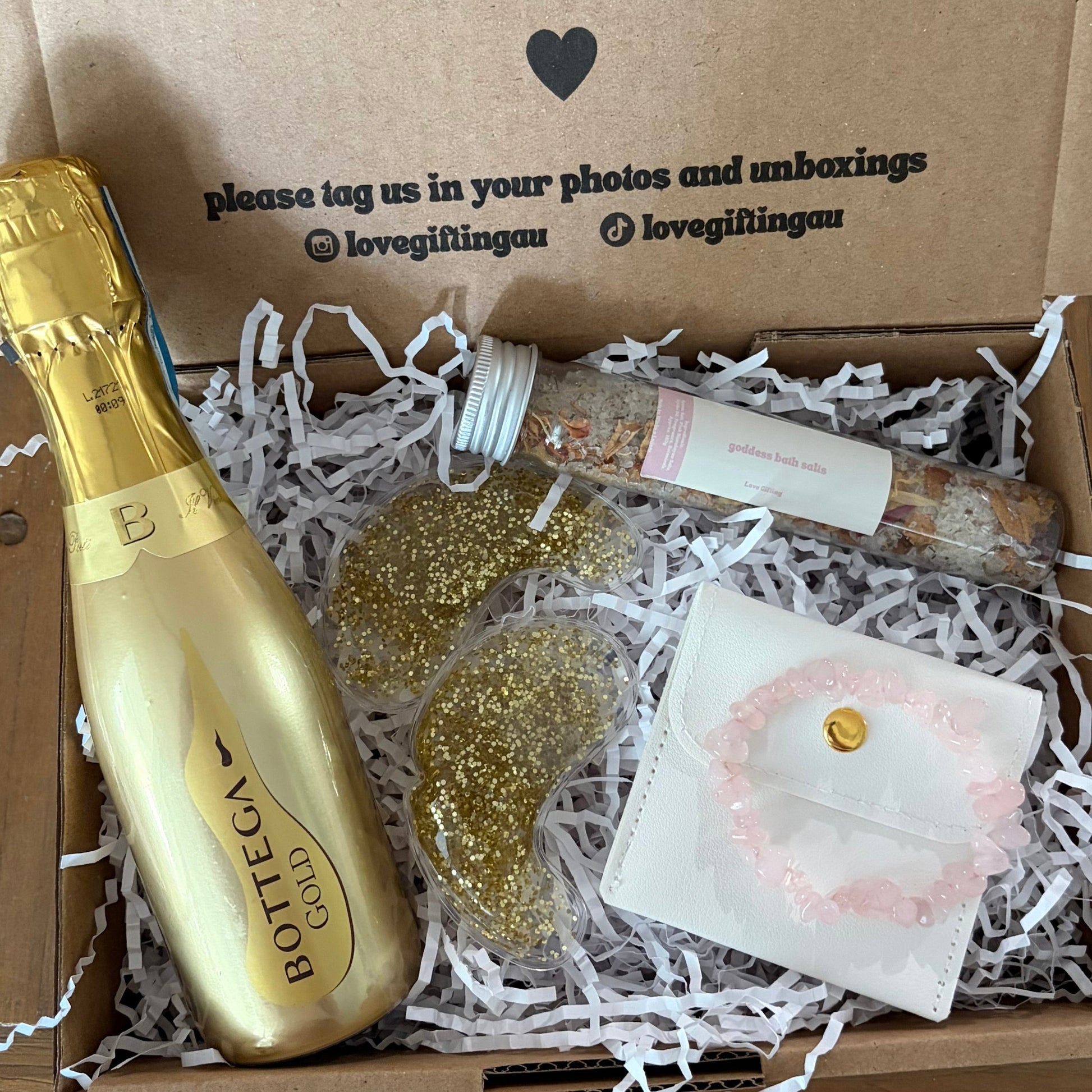 Gift box with Bottega prosecco bottle, glittery eye masks, rose quartz bracelet and goddess salts