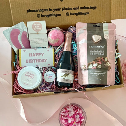 30th birthday gift box full of rocky road, prosecco, candle, bath bomb, 30th bracelet, under eye mask, and birthday cake lipbalm. Choice of sparkle claw clip or chocolate