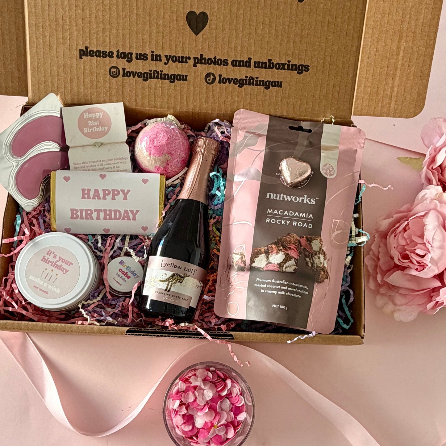 50th birthday gift box full of rocky road, prosecco, candle, bath bomb, 50th bracelet, under eye mask, and birthday cake lipbalm. Choice of sparkle claw clip or chocolate