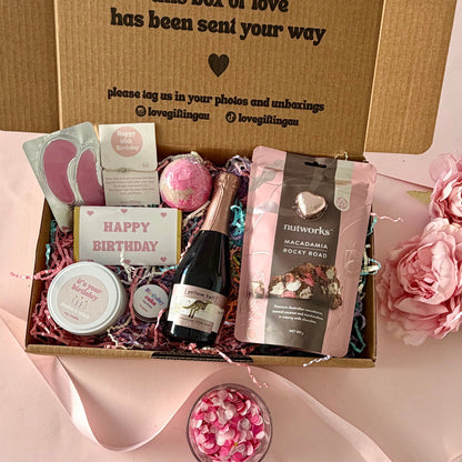  60th birthday gift box full of rocky road, prosecco, candle, bath bomb, 60th bracelet, under eye mask, and birthday cake lipbalm. Choice of sparkle claw clip or chocolate