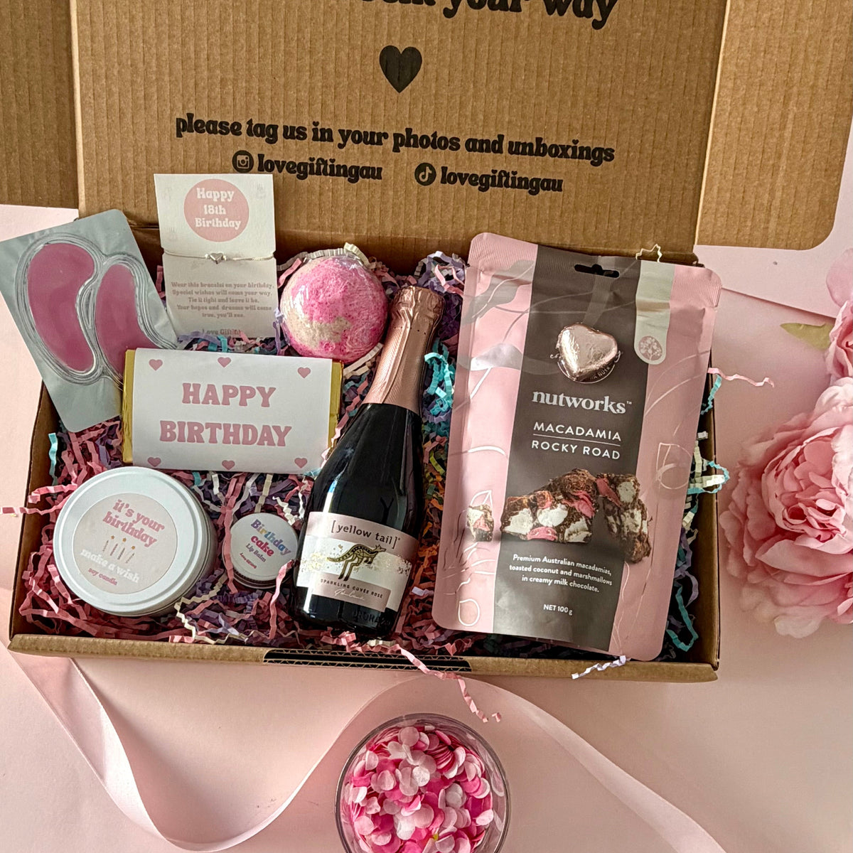 18th birthday gift box full of rocky road, prosecco, candle, bath bomb, 18th bracelet, under eye mask, amd birthday cake lipbalm. Choice of sparkle claw clip or chocolate