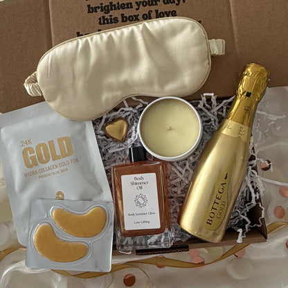 Gift box includes Gold prosecco, gold sleep mask, gold lapcos facemask amd candle