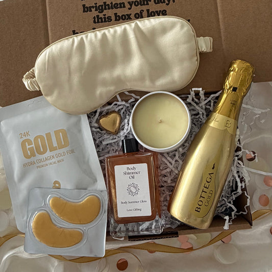Gift box includes Gold prosecco, gold sleep mask, gold lapcos facemask amd candle