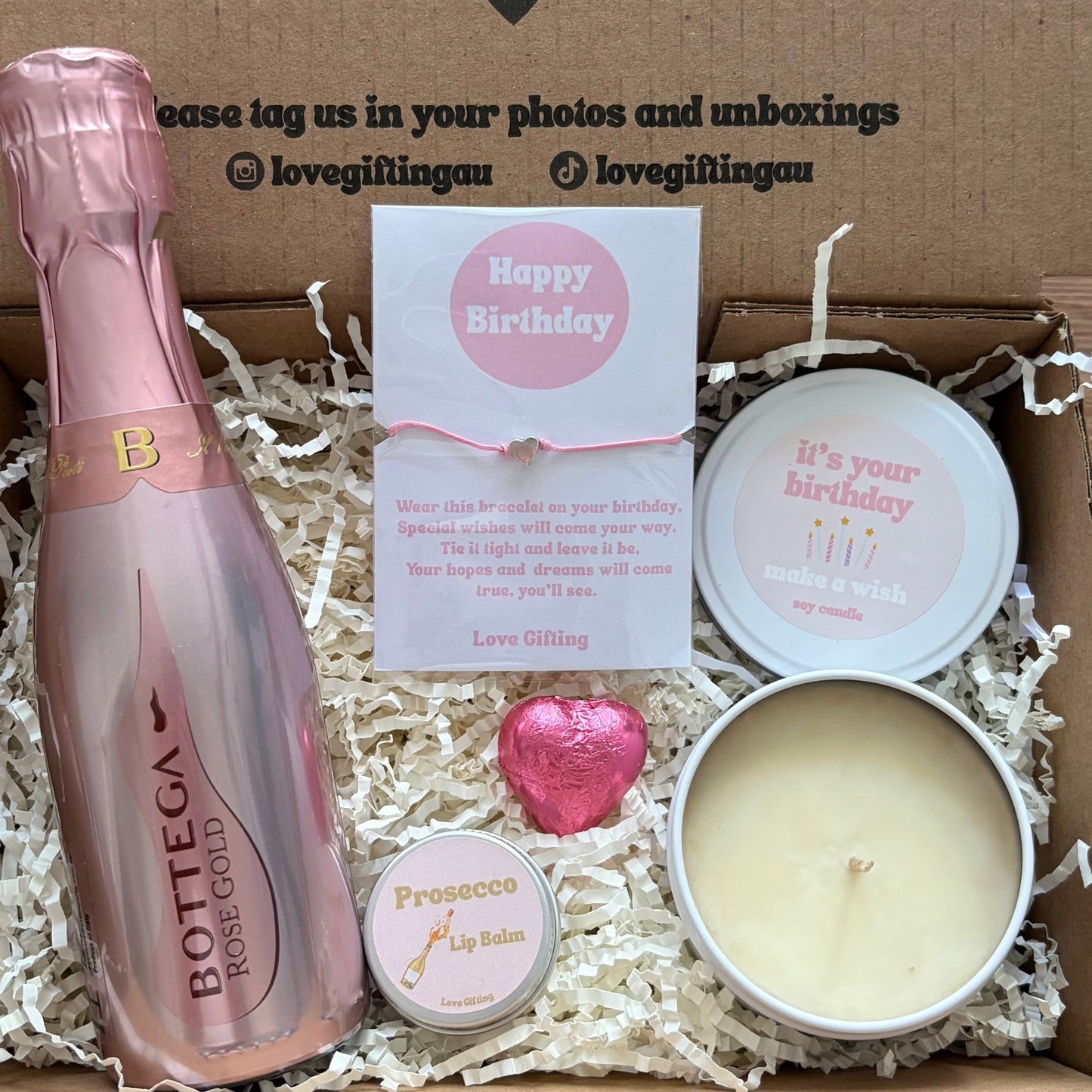 Gift box with Bottega Veneta bottle, candle, and card inside