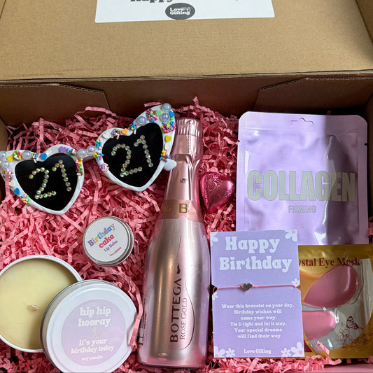 Gift box with birthday-themed items including a bottle, sunglasses, and collagen packaging.