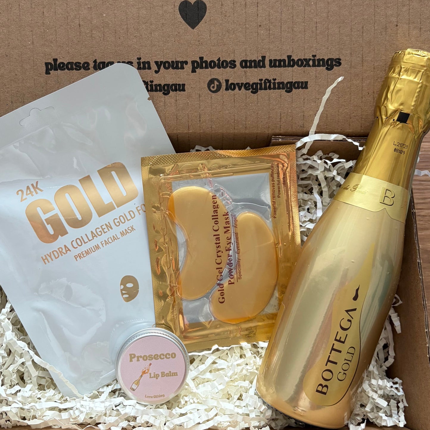 Gift box with gold bottle, gold packaging, and white product inside, branded 'Bottica'.
