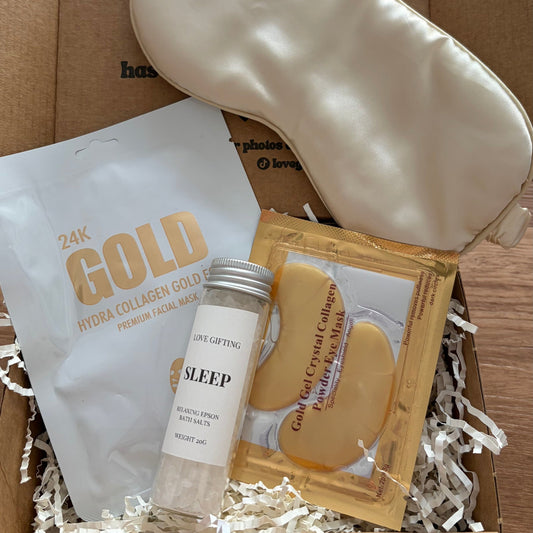 Sleep product set including a sleep mask, cream, and face masks in a box.