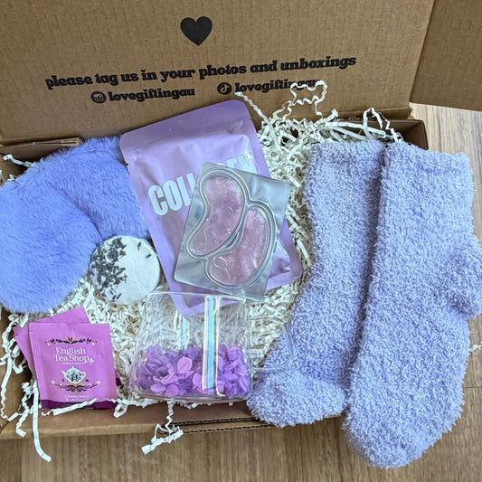 Box of goodies with a message on a wooden floor