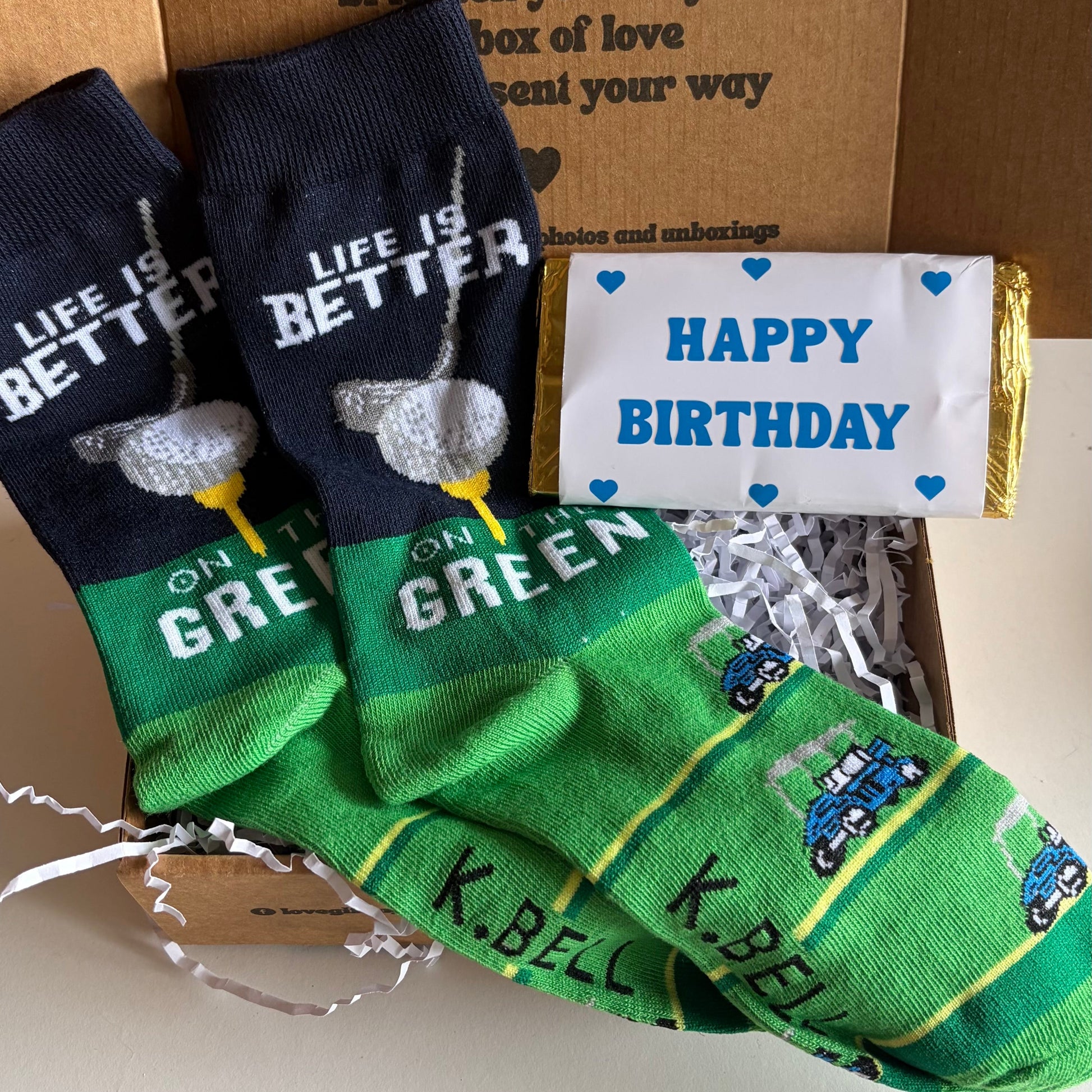Golf socks with text and a small birthday chocolate bar
