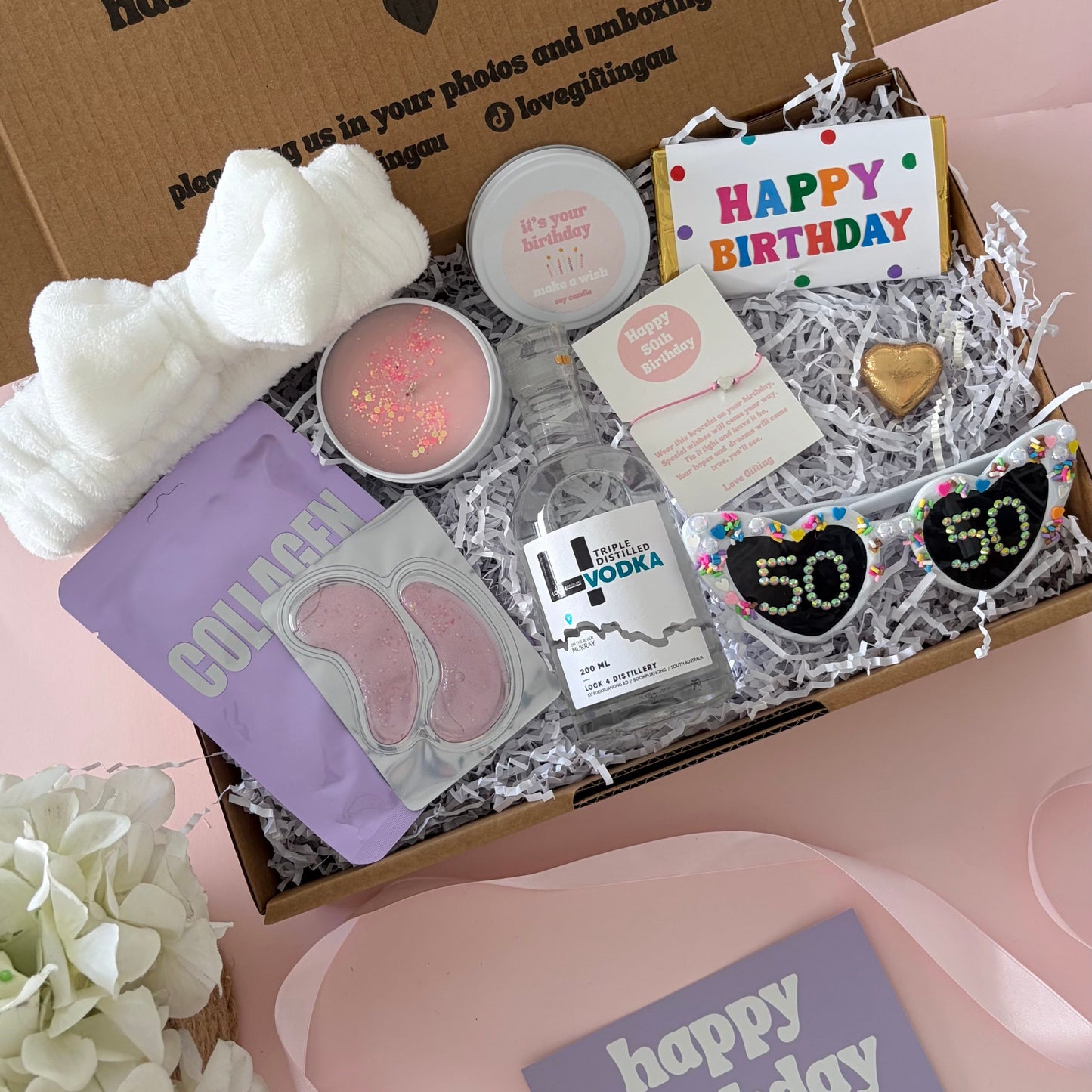 Vodka birthday box includes face mask, under eye, candle , glasses , happy birthday chocolate and 50th birthday bracelet
