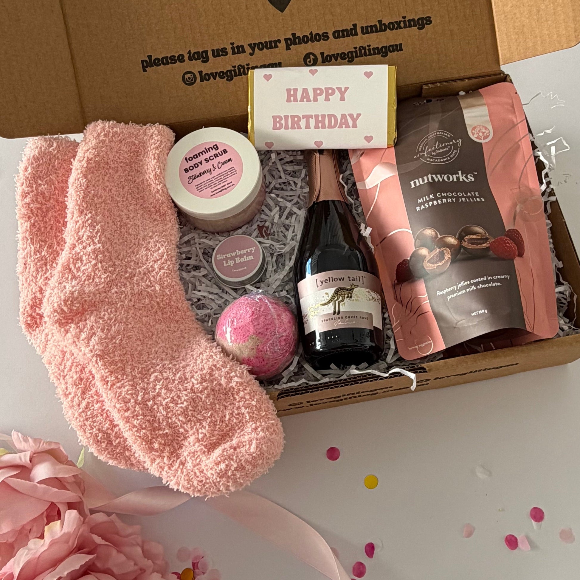 A curated birthday pamper gift box set  featuring strawberry bath bomb,Nutworks chocolate raspberries, istrawberry and cream foaming scrub and strawberry lipbalm 
