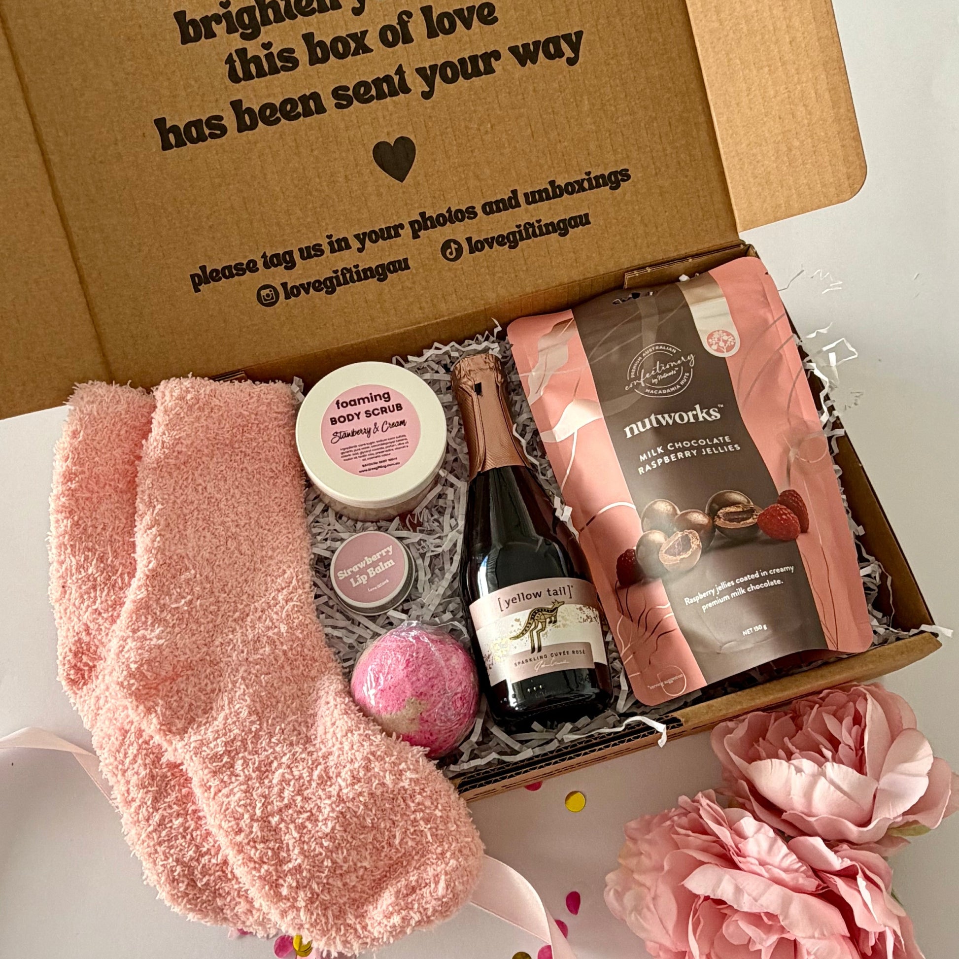 A curated birthday pamper gift box set  featuring strawberry bath bomb,Nutworks chocolate raspberries, istrawberry and cream foaming scrub and strawberry lipbalm 