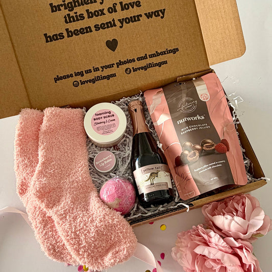 A curated birthday pamper gift box set  featuring strawberry bath bomb,Nutworks chocolate raspberries, istrawberry and cream foaming scrub and strawberry lipbalm 