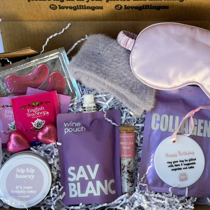 Birthday Gift box with satin sleep mask, Sav blanc wine pouch , collagen facemask sheet, bath salt shot, teabags, under eye mask, fluffy socks and happy birthday keepsake and candle.
