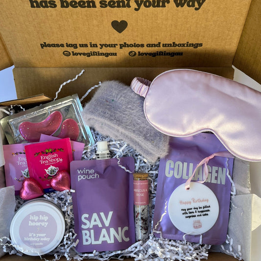 Birthday Gift box with satin sleep mask, Sav blanc wine pouch , collagen facemask sheet, bath salt shot, teabags, under eye mask, fluffy socks and happy birthday keepsake and candle.