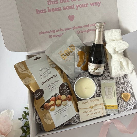 Luxury birthday gift box for her with sparkling wine, chocolate, gold pamper gifts, candle and heart bracelet
