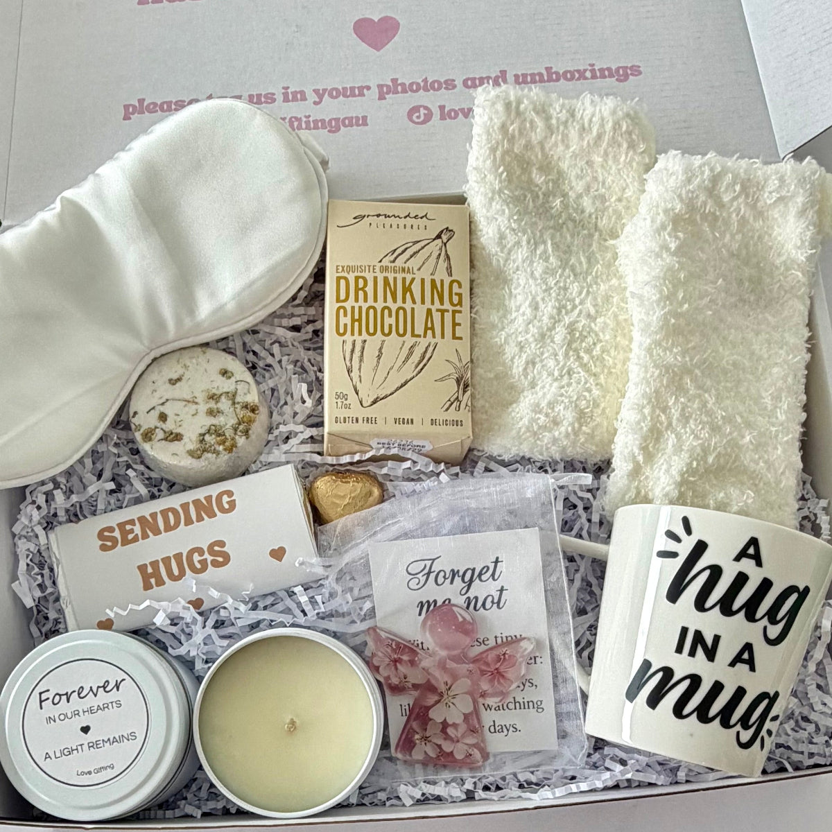 Thoughtful sympathy care package featuring a Hug in a Mug, comforting candle, sweet treats and cosy essentials, delivered Australia-wide