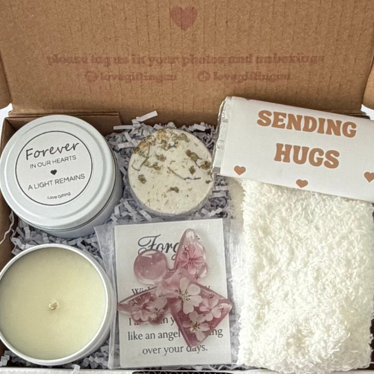 Forever in Our Hearts sympathy gift box featuring a remembrance candle, ceramic Hug in a Mug, fluffy socks, drinking chocolate and comforting gifts for someone grieving.