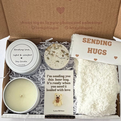 Sending a Gentle Hug sympathy gift box featuring Sending Love, Light & Comfort candle, shower steamer, cosy socks, chocolate and mini bear keepsake.