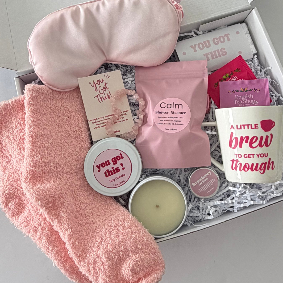 You've Got This comfort and self care gift box with pink fluffy socks, satin sleep mask, shower steamer, soy candle, mug, tea and pampering treats.