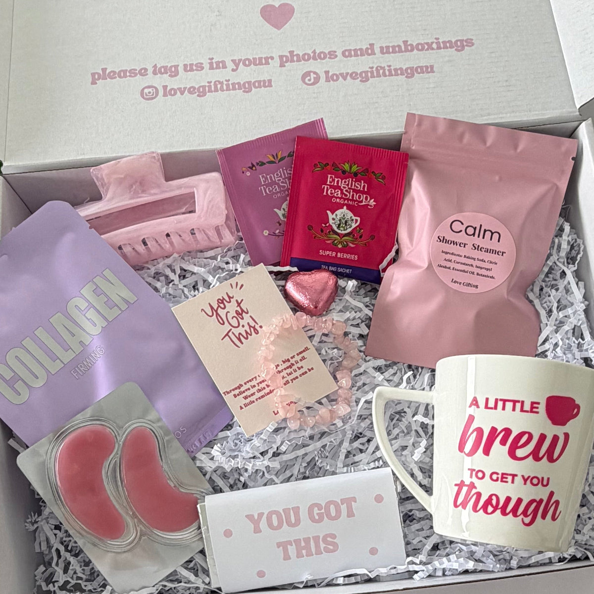 You've Got This pick me up gift box for her featuring pink ceramic mug, organic tea, rose quartz bracelet, Calm shower steamer, face masks, chocolates and self-care treats.