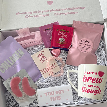 You've Got This pick me up gift box for her featuring pink ceramic mug, organic tea, rose quartz bracelet, Calm shower steamer, face masks, chocolates and self-care treats.