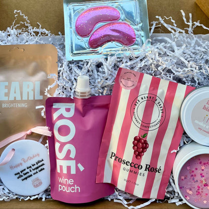 Birthday gift box which includes Rose wine pouch, happy birthday keepsake, pearl Lapcos face mask sheet, under eye masks, happy birthday candle and rose gummies