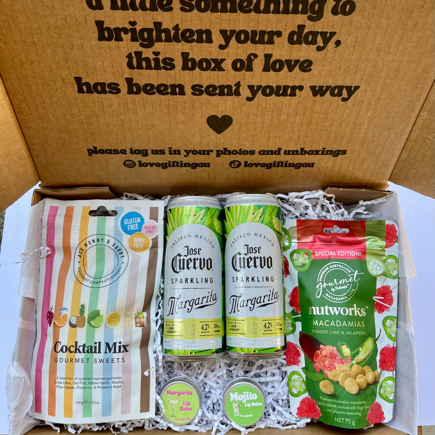 Gift box with Jose Cuervo margarita cans, cocktail mix, Jalapeno nutworks macadamia nuts and lip balms