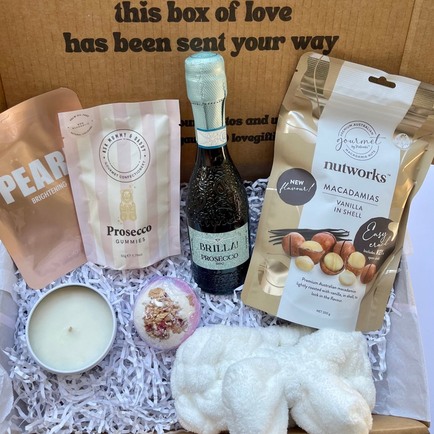 Gift box with Prosecco, prosecco gummies, Pearl face mask sheet, bath bomb, candle, headband and nuts