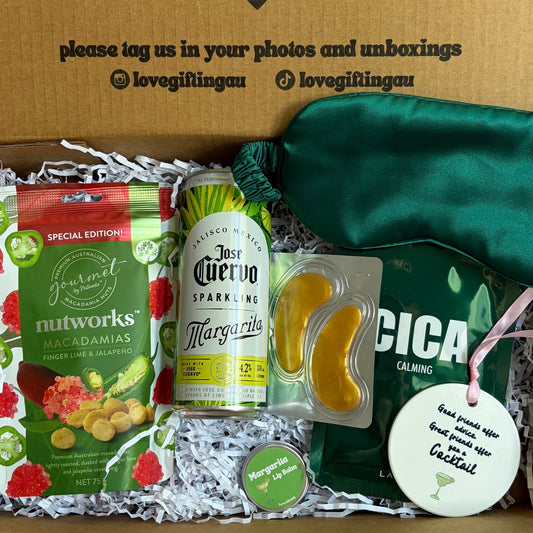 Cocktail Gift box with snacks, a bottle, and a green bag on a white background
