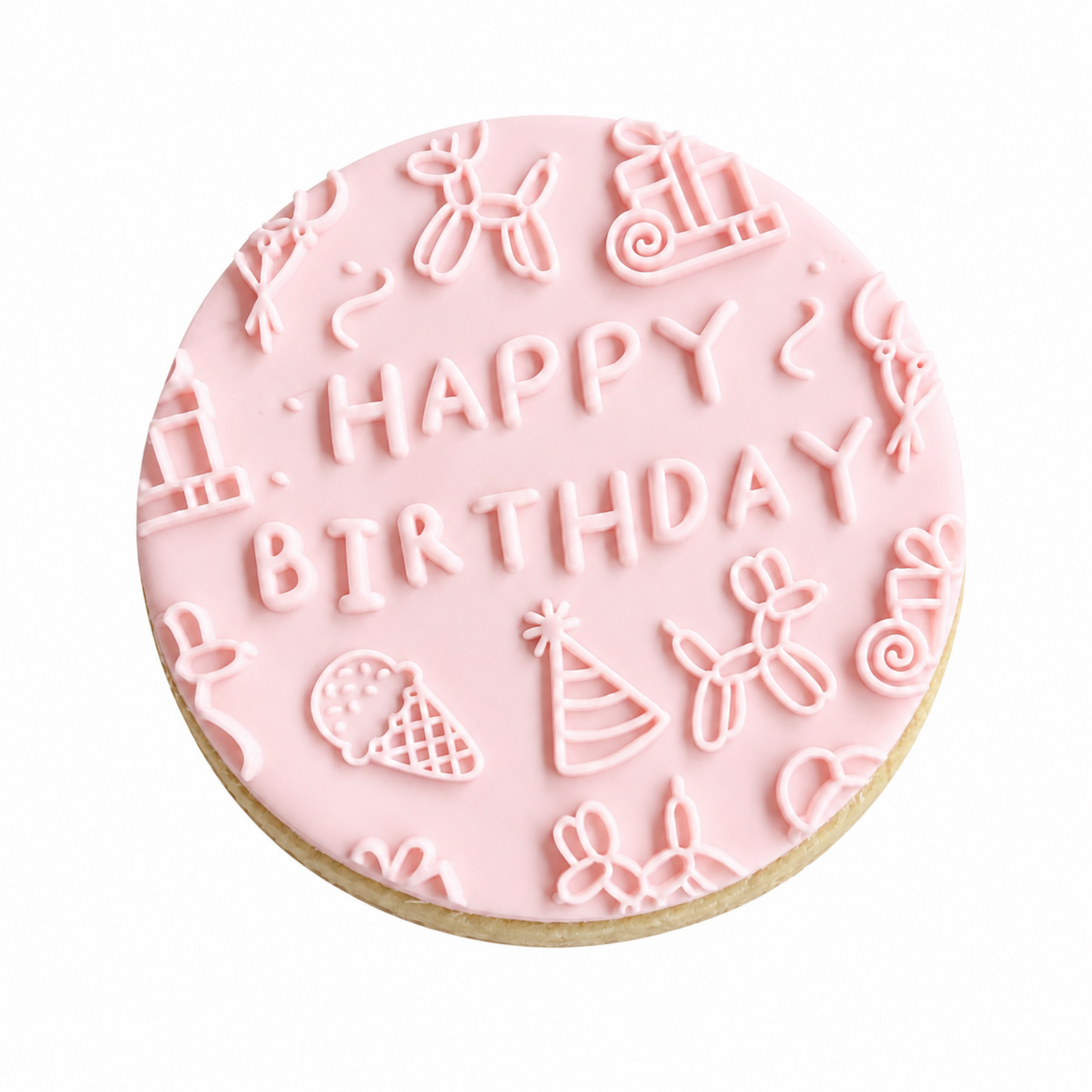 A round birthday cookie with light pink icing, featuring the words 'HAPPY BIRTHDAY' in raised letters surrounded by small festive illustrations like balloons, an ice cream cone, a party hat, and swirls, on a white background.